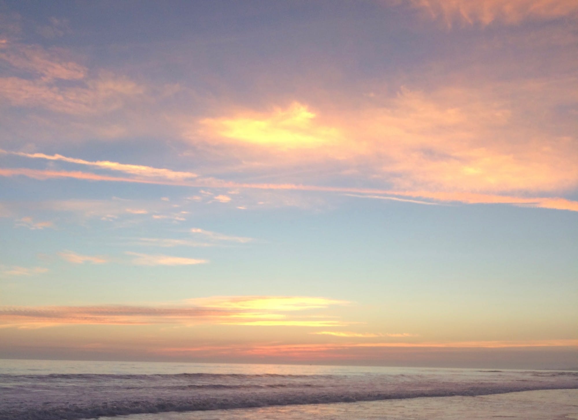 A soft pink and blue sunset over the ocean